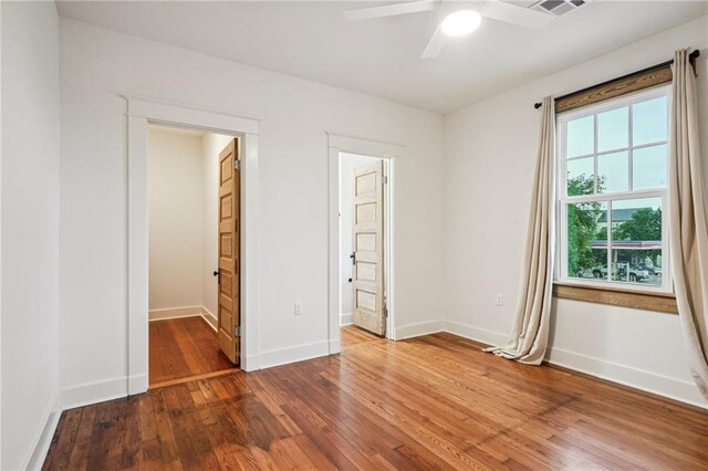 720 Moss St, New Orleans, LA 70119 - unfurnished bedroom featuring hardwood / wood-style flooring, ensuite bathroom, and a ceiling fan
