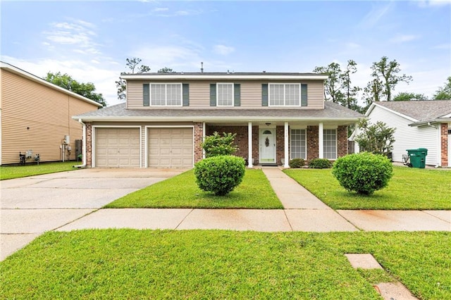 430 Holmes Dr, Slidell, LA 70460 - traditional home with brick siding, an attached garage, driveway, and a front lawn