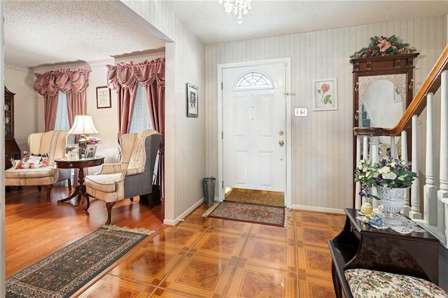 430 Holmes Dr, Slidell, LA 70460 - entrance foyer featuring baseboards, a textured ceiling, and wallpapered walls