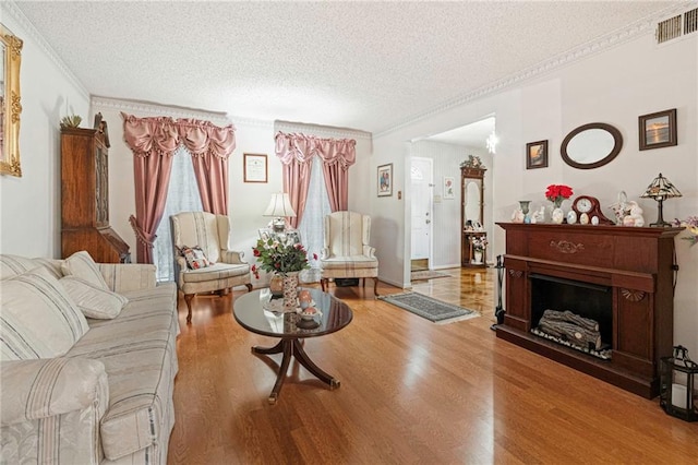 430 Holmes Dr, Slidell, LA 70460 - living room with a textured ceiling, wood finished floors, visible vents, and crown molding