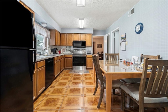 430 Holmes Dr, Slidell, LA 70460 - kitchen with brown cabinets, light countertops, a sink, black appliances, and a textured ceiling