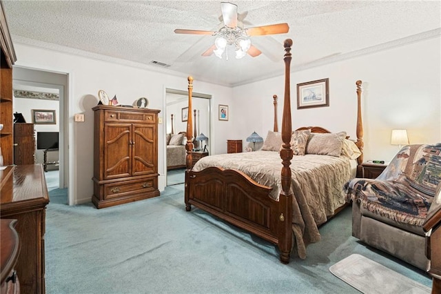 430 Holmes Dr, Slidell, LA 70460 - carpeted bedroom with visible vents, a ceiling fan, ornamental molding, a closet, and a textured ceiling