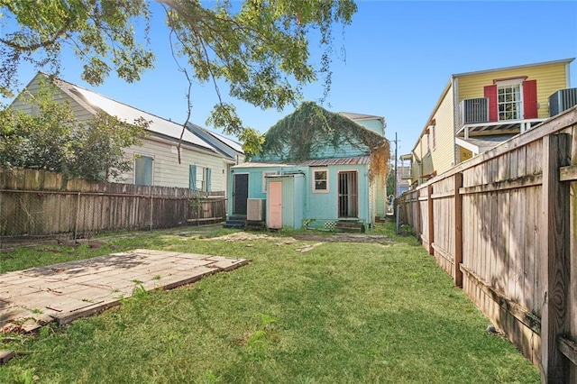 201921 N Rampart St, New Orleans, LA 70116 - view of yard with central AC, an outbuilding, a fenced backyard, and entry steps