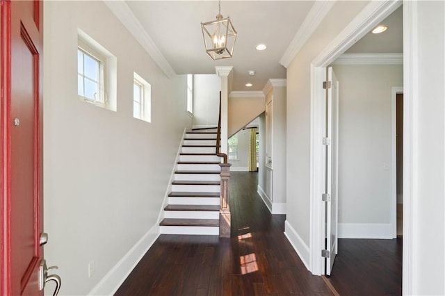 417 28th St, New Orleans, LA 70124 - foyer with dark wood-type flooring, stairway, baseboards, a chandelier, and ornamental molding