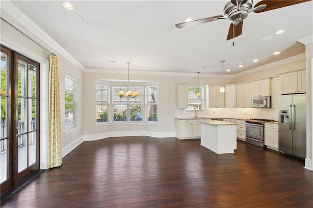 417 28th St, New Orleans, LA 70124 - kitchen with appliances with stainless steel finishes, a chandelier, light countertops, baseboards, and a kitchen island