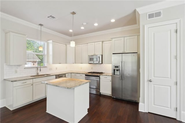 417 28th St, New Orleans, LA 70124 - kitchen with appliances with stainless steel finishes, a sink, white cabinets, crown molding, and recessed lighting