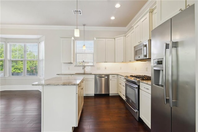 417 28th St, New Orleans, LA 70124 - kitchen with appliances with stainless steel finishes, a sink, a center island, ornamental molding, and tasteful backsplash