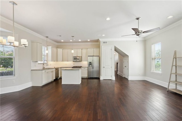 417 28th St, New Orleans, LA 70124 - kitchen featuring stainless steel appliances, a center island, dark wood finished floors, light countertops, and tasteful backsplash