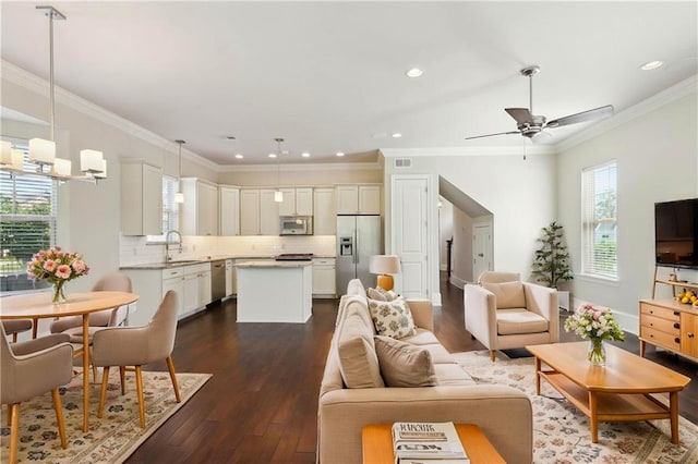 417 28th St, New Orleans, LA 70124 - living room featuring dark wood-type flooring, ceiling fan, ornamental molding, and recessed lighting