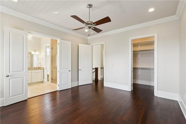 417 28th St, New Orleans, LA 70124 - unfurnished bedroom featuring dark wood-style flooring, baseboards, crown molding, a spacious closet, and recessed lighting