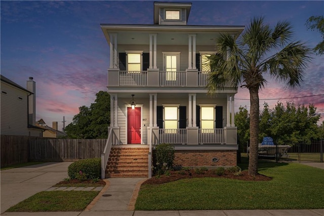 417 28th St, New Orleans, LA 70124 - view of front of property featuring a balcony, covered porch, and driveway