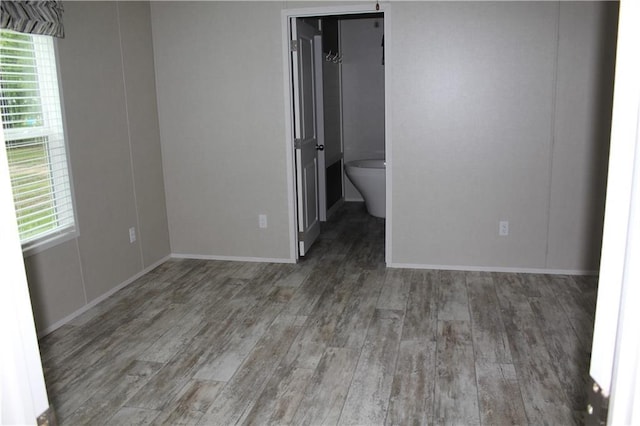 unfurnished bedroom featuring baseboards and wood finished floors