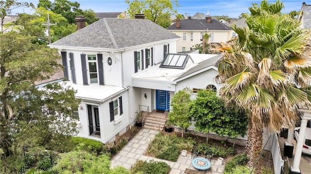 1704 Milan St, New Orleans, LA 70115 - view of front facade with a shingled roof and a chimney