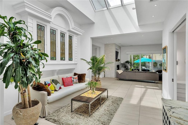 1704 Milan St, New Orleans, LA 70115 - living area with a skylight, light tile patterned floors, recessed lighting, and a high ceiling