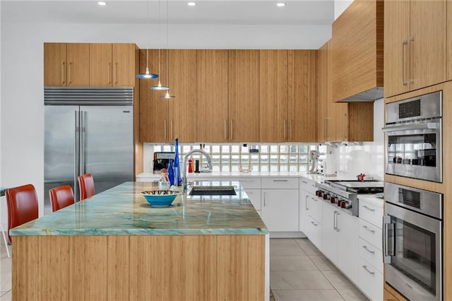 1704 Milan St, New Orleans, LA 70115 - kitchen featuring stainless steel appliances, an island with sink, recessed lighting, and a sink