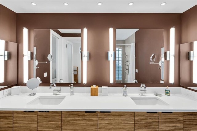 1704 Milan St, New Orleans, LA 70115 - bathroom with toilet, a stall shower, recessed lighting, and a sink