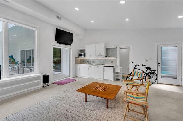 1704 Milan St, New Orleans, LA 70115 - living area featuring visible vents, vaulted ceiling, light carpet, and recessed lighting