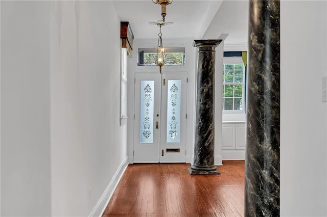 1704 Milan St, New Orleans, LA 70115 - entryway featuring baseboards, decorative columns, and wood finished floors
