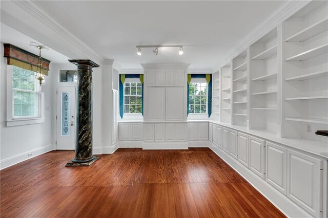 1704 Milan St, New Orleans, LA 70115 - interior space featuring dark wood-style floors, ornate columns, and baseboards