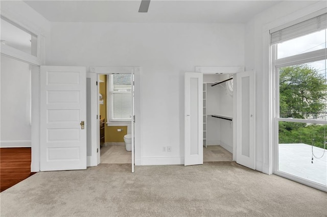 1704 Milan St, New Orleans, LA 70115 - unfurnished bedroom featuring carpet, connected bathroom, access to outside, and multiple windows