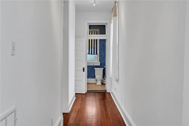 1704 Milan St, New Orleans, LA 70115 - hall with dark wood-style flooring, visible vents, and baseboards