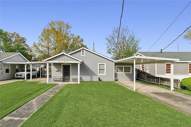 8335 Huntley Ln, Harahan, LA 70123 - bungalow with a front lawn, an attached carport, fence, and driveway
