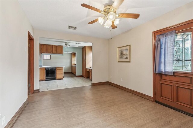 8335 Huntley Ln, Harahan, LA 70123 - unfurnished living room with baseboards, a ceiling fan, visible vents, and light wood-style flooring
