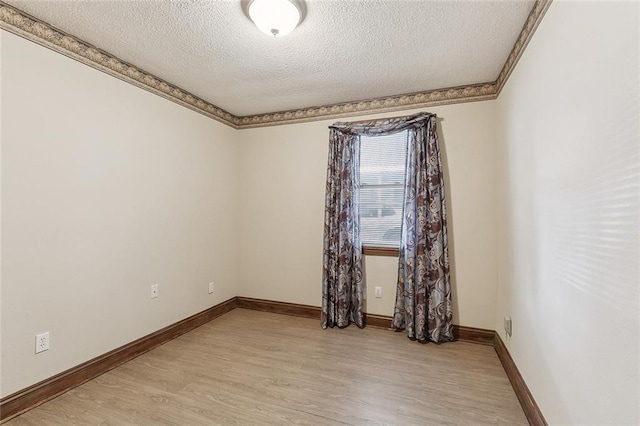 8335 Huntley Ln, Harahan, LA 70123 - unfurnished room featuring light wood-style flooring, baseboards, a textured ceiling, and crown molding