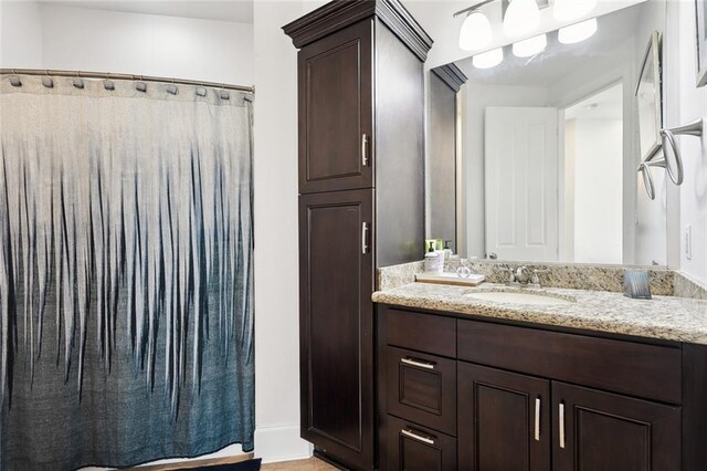 544 Belle Pointe Loop, Madisonville, LA 70447 - full bathroom featuring baseboards, vanity, and a shower with curtain