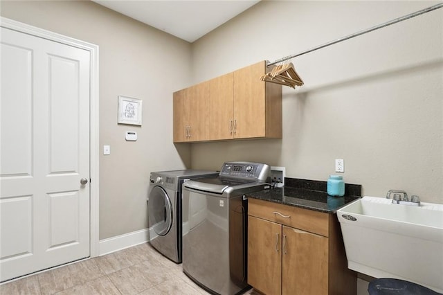 544 Belle Pointe Loop, Madisonville, LA 70447 - laundry room featuring washer and clothes dryer, a sink, light tile patterned floors, cabinet space, and baseboards