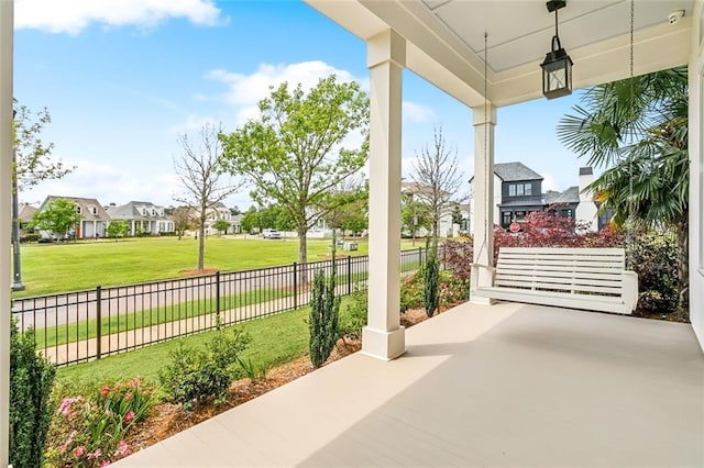 view of patio / terrace with a residential view and fence