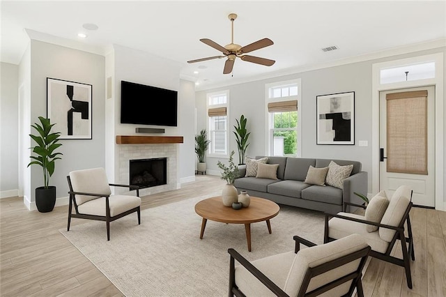 640 Bocage Ct N, Covington, LA 70433 - living room with light wood finished floors, a ceiling fan, a tile fireplace, baseboards, and recessed lighting