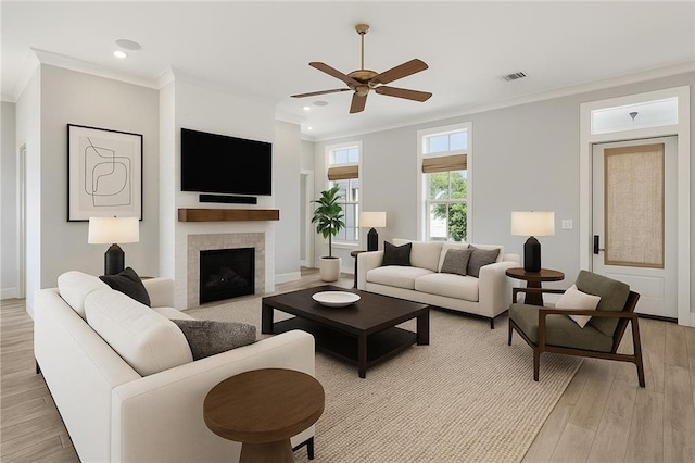 640 Bocage Ct N, Covington, LA 70433 - living room with ceiling fan, ornamental molding, light wood finished floors, recessed lighting, and a fireplace with flush hearth