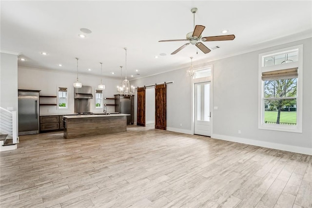 640 Bocage Ct N, Covington, LA 70433 - kitchen with built in refrigerator, ventilation hood, a barn door, open shelves, and recessed lighting