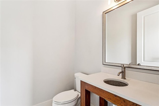 half bath featuring toilet and vanity