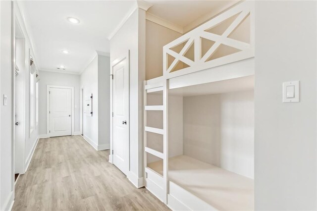 hall featuring ornamental molding, wood finished floors, and baseboards