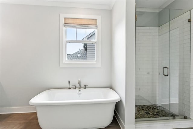 640 Bocage Ct N, Covington, LA 70433 - bathroom featuring baseboards, a shower stall, and a freestanding tub