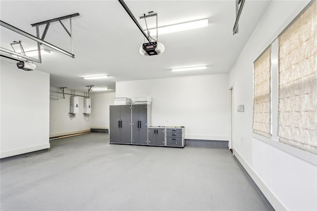 640 Bocage Ct N, Covington, LA 70433 - garage featuring a garage door opener, baseboards, and water heater