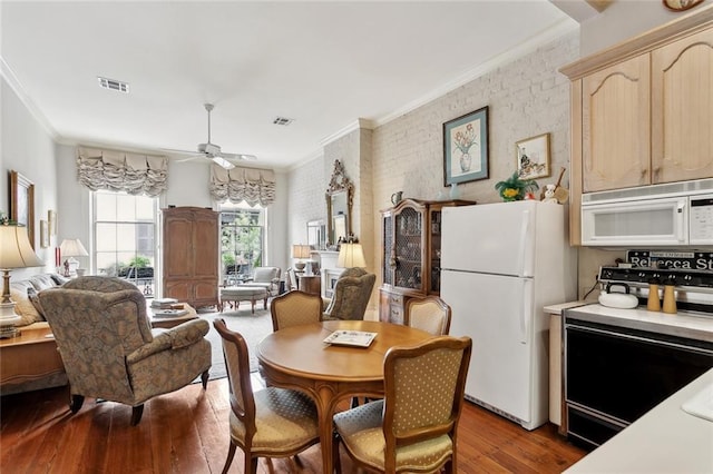 931 Chartres Street 13&14, New Orleans, LA 70116 - dining room with ceiling fan, crown molding, wood finished floors, and visible vents