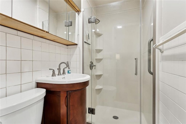 931 Chartres Street 13&14, New Orleans, LA 70116 - bathroom featuring tasteful backsplash, a shower stall, toilet, tile walls, and vanity