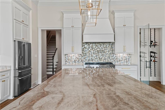 kitchen featuring white cabinets, high quality fridge, ornamental molding, and backsplash