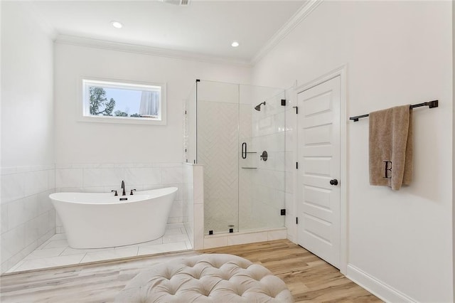 16202 W Bennett Rd, Loranger, LA 70446 - full bathroom featuring a shower stall, a soaking tub, ornamental molding, wood finished floors, and tile walls