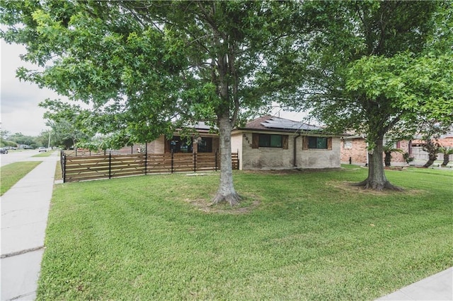 5613 W Esplanade Ave, Metairie, LA 70003 - single story home featuring roof mounted solar panels, a front yard, and fence