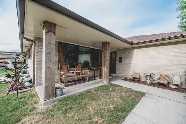 5613 W Esplanade Ave, Metairie, LA 70003 - rear view of property featuring brick siding and a patio area