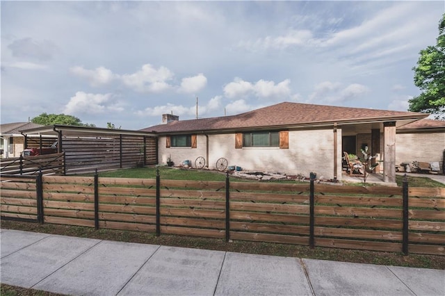 5613 W Esplanade Ave, Metairie, LA 70003 - ranch-style home featuring brick siding, a chimney, and a fenced front yard
