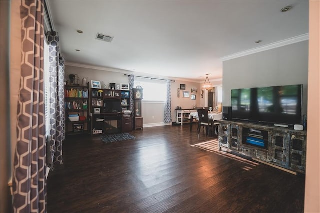 5613 W Esplanade Ave, Metairie, LA 70003 - living room with baseboards, visible vents, a notable chandelier, wood finished floors, and crown molding