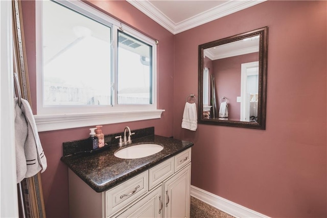 5613 W Esplanade Ave, Metairie, LA 70003 - bathroom featuring baseboards, crown molding, and vanity