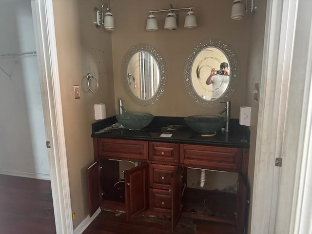 7645 Lady Gray St, New Orleans, LA 70127 - full bath with double vanity, baseboards, wood finished floors, and a sink