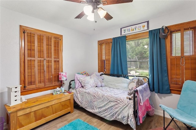 bedroom with ceiling fan and wood finished floors