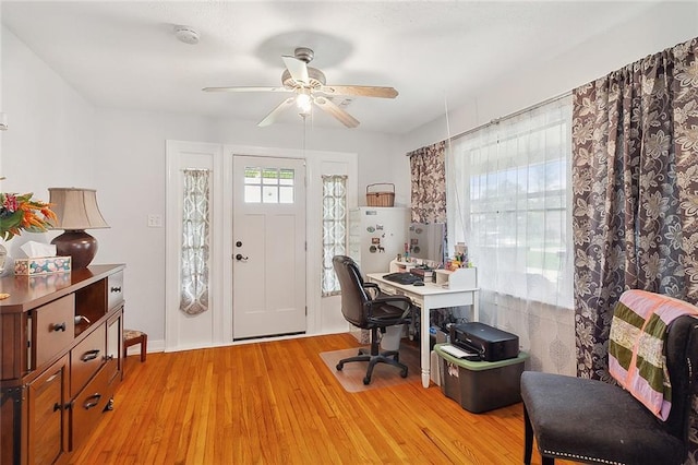 office area with a ceiling fan and light wood-type flooring